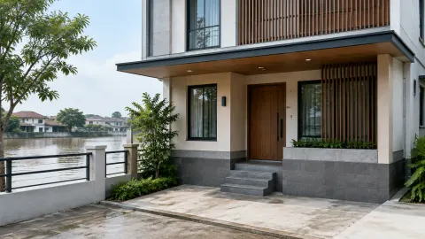 Rumah dua lantai dengan teras dan tangga menuju pintu depan