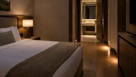 Kamar penginapan dengan lampu jalur menuju kamar mandi
