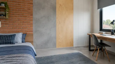 Kamar remaja dengan dinding bata, beton, dan panel kayu