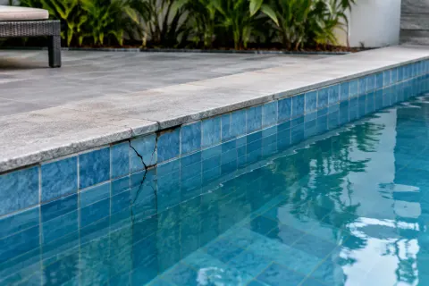 Retakan pada tepi batu kolam renang