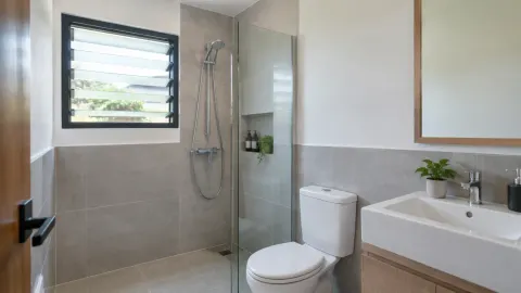 Jendela berkisi pada kamar mandi dengan area pancur